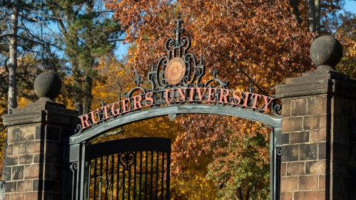 A view of Rutgers University main gate at Somerset Street to Old Queens surrounded by bright autumn foliage