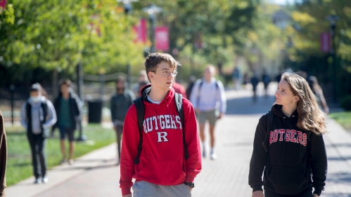 students walking on campus wearing Rutgers sweatshirts