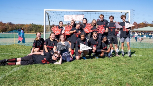 Rutgers Unified team poses in front of a soccer goal