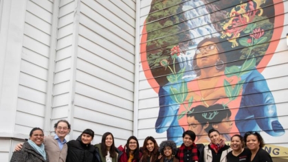 group of people in front of mural on the Center for Latino Arts and Culture