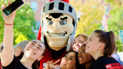 Group of students posing with RU Mascot