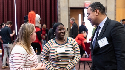 two students talk with Vice Chancellor Salvador Mena