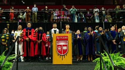 students Jonathan Freire and Jordany Arias with university leaders on stage