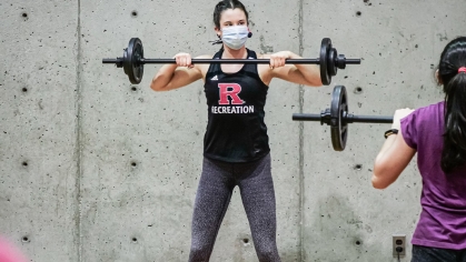 fitness instructor leads a weight-lifting class at Rutgers Recreation