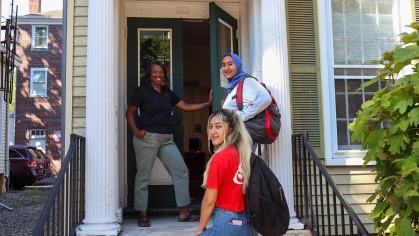 staff and students on the steps of entrance to Dean of Students office