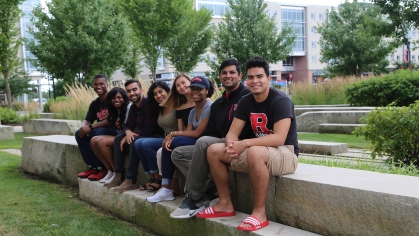 group of students sit together outside on Livingston Campus