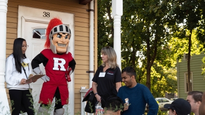 off-campus living and community partnerships staff with Scarlet Knight mascot