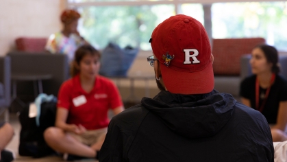 student wears Rutgers baseball cap
