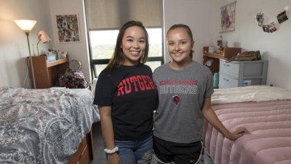 two students standing in their dorm room