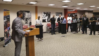 person a podium speaking to a crowd