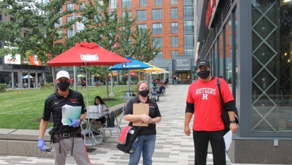 three staff members standing outside wearing face masks