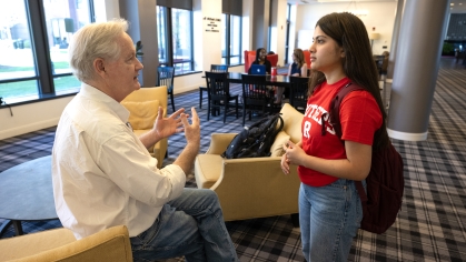 Faculty converse's with student