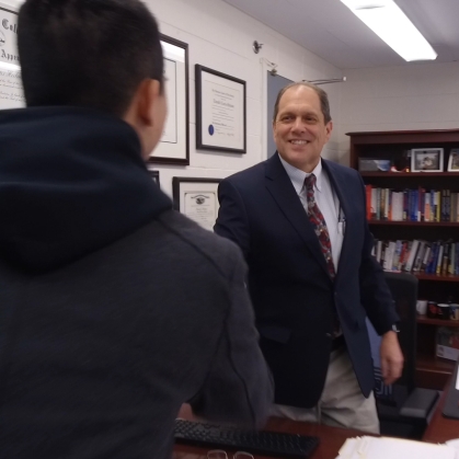student greets staff member from Rutgers Student Legal Services