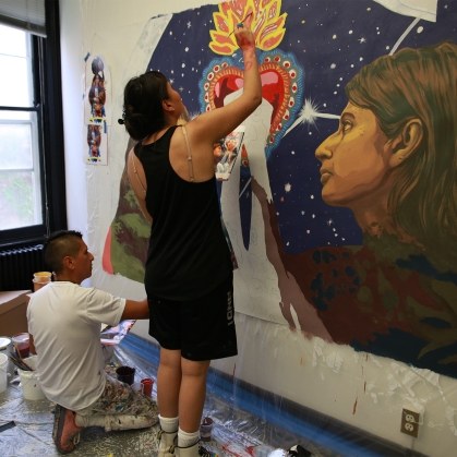 people painting an indoor mural for CLAC community art project