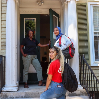 staff and students on the steps of entrance to Dean of Students office