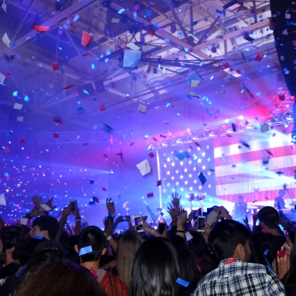 confetti flies over dancing crowd