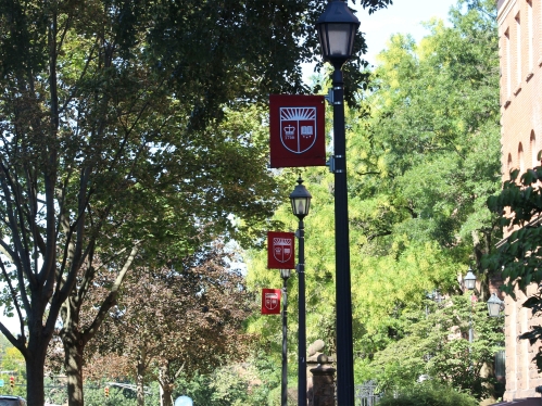 light posts with banners of the Rutgers shield line the street