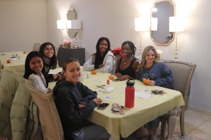 Members of the Coalition for Women of Color sit at a table