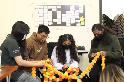 Student employees prepare the decorations for Queer Garba. From L-R: Judy Yeung, Om Patil, Neda Sayyed, and Mitra Raveendran