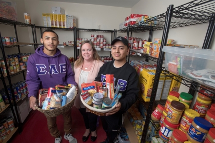 students hold baskets of food at Rutgers Student Food Pantry