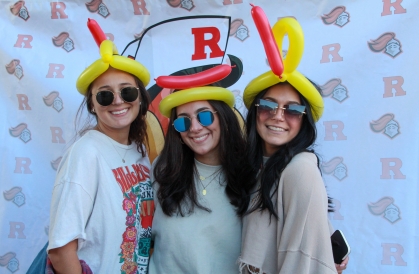 Students pose with Hot Dog Day hats in Spring 2022