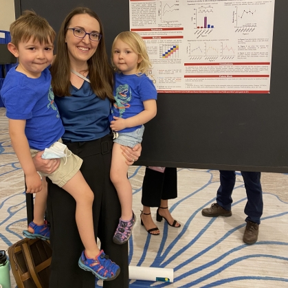 Emily Hanselman poses with her research and her kids