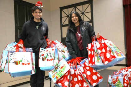 RUPA studenst pose for a photo with wrapped presents