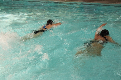 Two swimmers practice their freestyle at Swim for Life