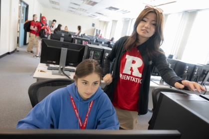 Student helping another student with class schedule